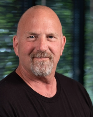 portrait of a smiling person in a black shirt